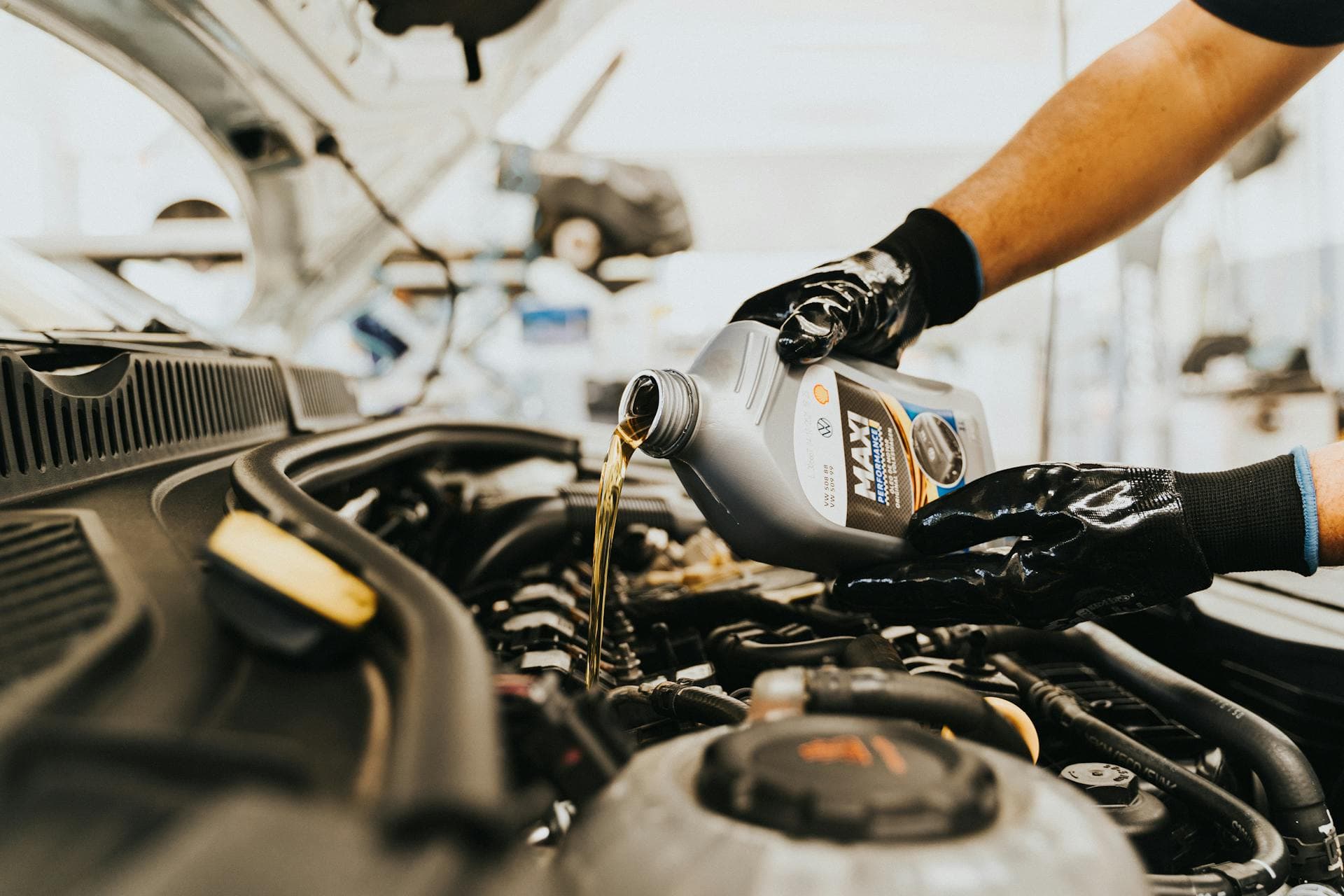Professionelle Servicehistorie-Prüfung Mechaniker beim Ölwechsel im Vertragshändler